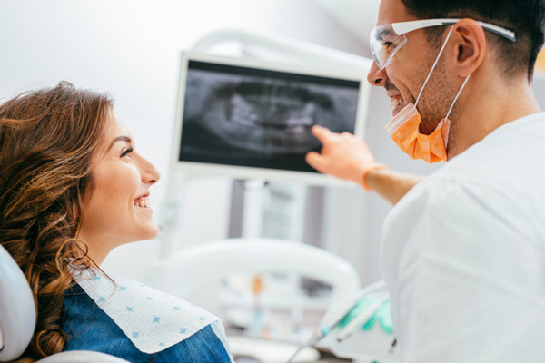 A Dr. and patient discussing gum grafting procedure